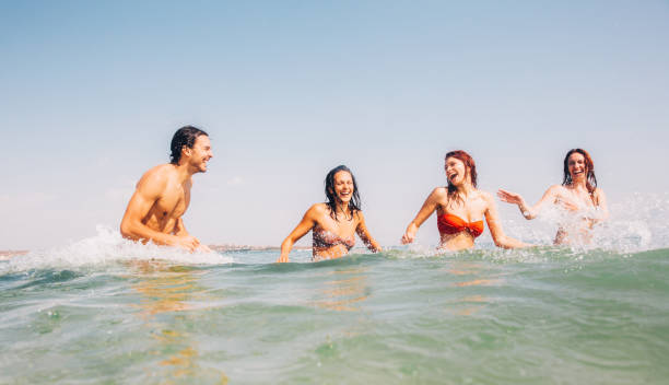 istock Friends having fun in the sea 693610674