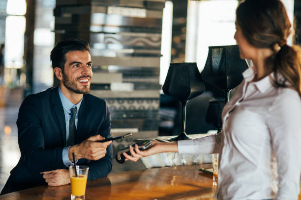 istock Businessman paying via smart phone 693610716