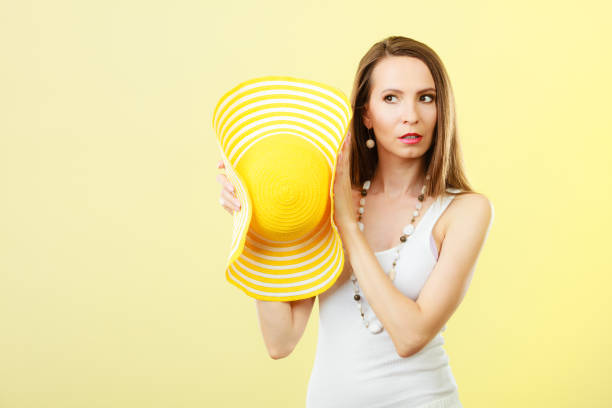 istock Woman in big yellow summer hat. 693611248