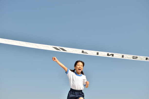 istock Girl running in blue sky (gym clothes, goal tape) 693614514