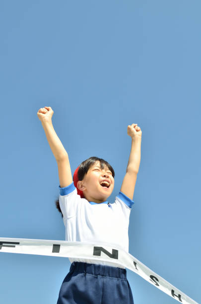 istock Girl running in blue sky (gym clothes, goal tape) 693616868
