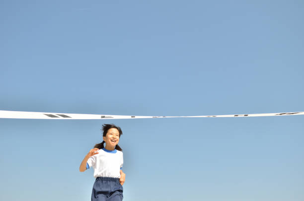 istock Girl running in blue sky (gym clothes, goal tape) 693617216