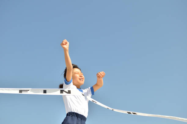 Girl running in blue sky (gym clothes, goal tape)