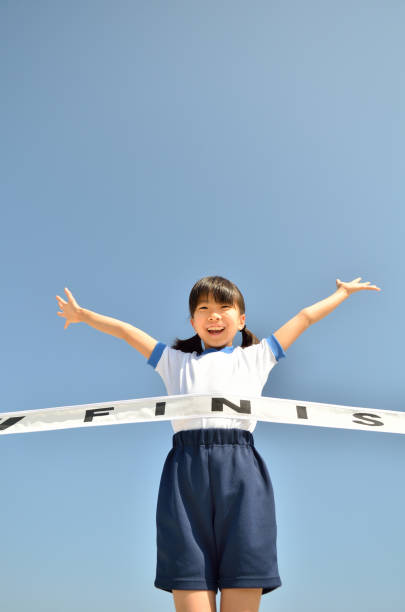 istock Girl running in blue sky (gym clothes, goal tape) 693617484