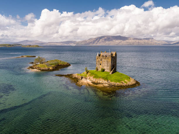 Aerial of the historic castle Stalker in Argyll Appin, Argyll / Scotland - May 14 2017 : Castle Stalker is a picturesque castle surrounded by water located 25 miles north of Oban on the west coast of Scotland scottish highlands castle stock pictures, royalty-free photos & images