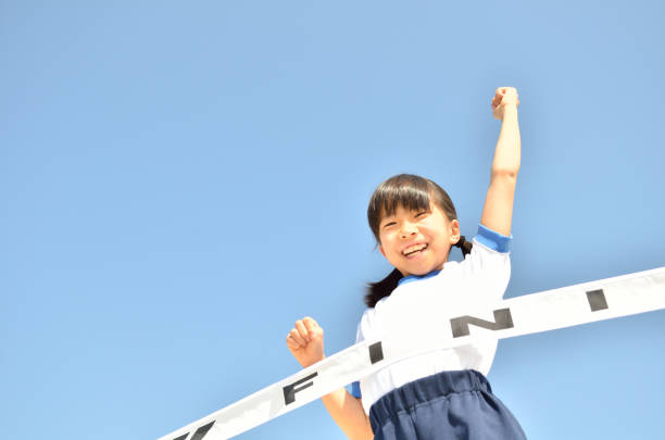 istock Girl running in blue sky (gym clothes, goal tape) 693617668