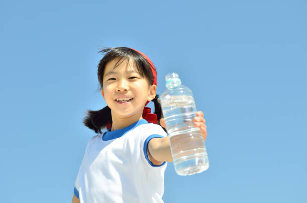 Cute expressive kid staying hydrated