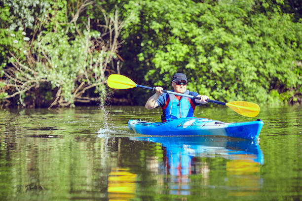 istock Man paddling a kayak on summer day. 693627418
