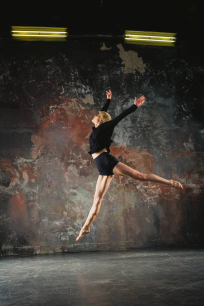 istock Dance. The girl dances in a black jacket 693628046
