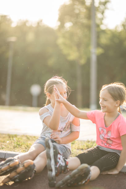 istock Two best friends after racing on roller skates. 693636846