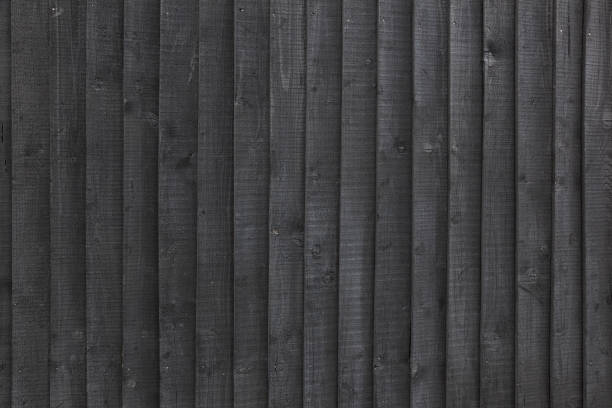 istock background black stained wooden planks on fencing 693637178