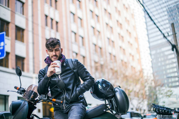 istock Handsome man sitting on motorbike 693638330