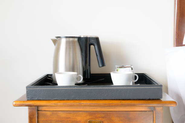 istock Coffee pot and white coffee cup for room service in hotel 693640478