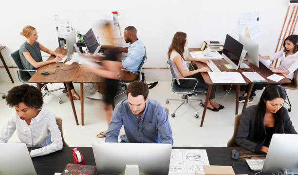 istock Man and woman with documents in an office, smiling, close up 693641324