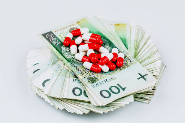 drugs - capsules on banknotes stock photo