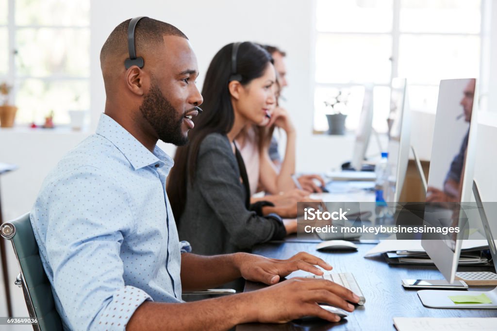 Man and woman with documents in an office, smiling, close up Customer Service Representative Stock Photo