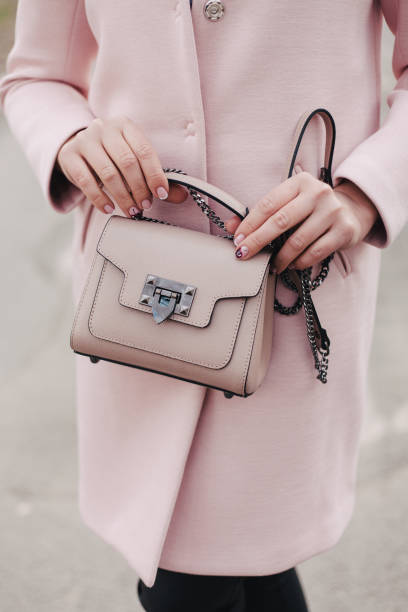 istock Girl holding a woman's bag in her hands 693649356