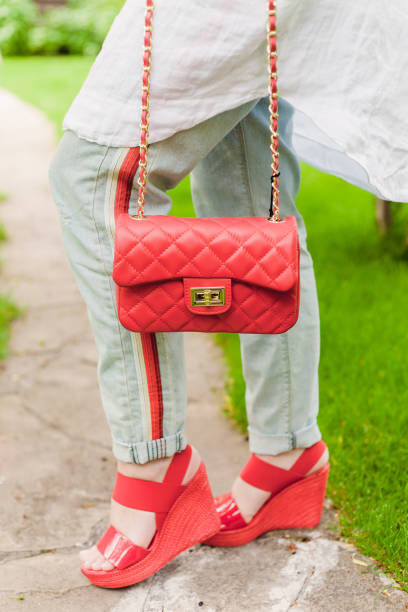 istock Girl holding a woman's bag in her hands 693649464
