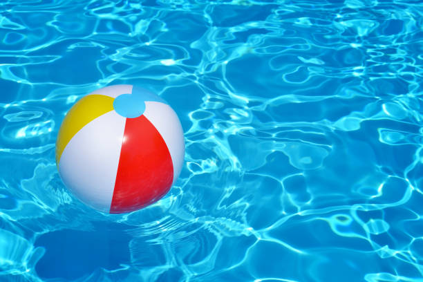 istock Colorful inflatable ball floating in swimming pool 693649912