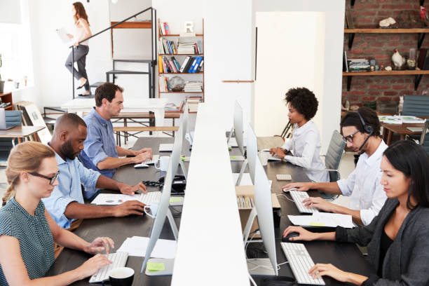 istock Man and woman with documents in an office, smiling, close up 693652316