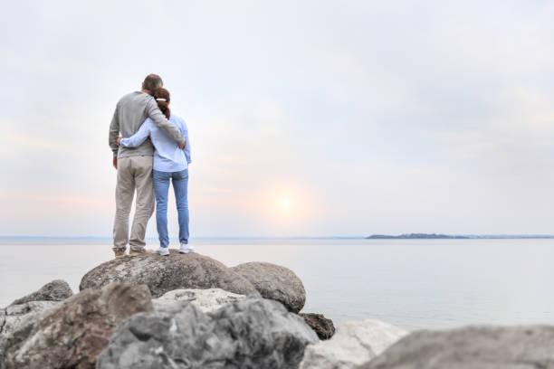 istock Sunrise - couple at the lake 693655564