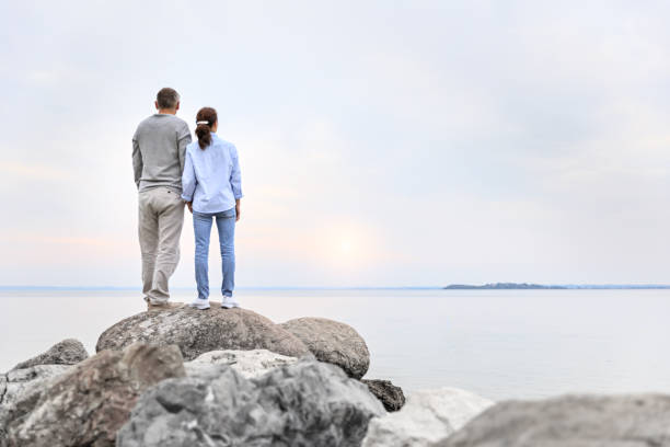 istock Sunrise - couple at the lake 693655582