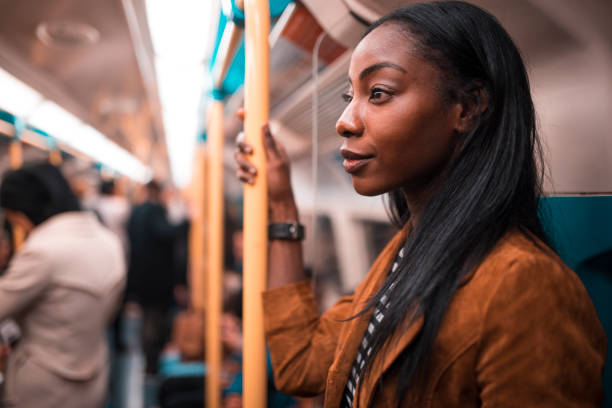 On my way to work Young woman traveling with metro in London, UK. london england rush hour underground train stock pictures, royalty-free photos & images