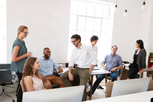 istock Man and woman with documents in an office, smiling, close up 693657790