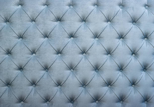 Blue capitone tufted fabric upholstery texture Light blue velvet capitone textile background, retro Chesterfield style checkered soft tufted fabric furniture diamond pattern decoration with buttons, close up derbyshire photos stock pictures, royalty-free photos & images