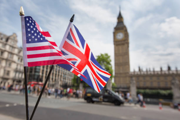 Union Jack flag and the Stars and Stripes flag of the USA, fluttering together in front of Big Ben in Westminster, London stock photo