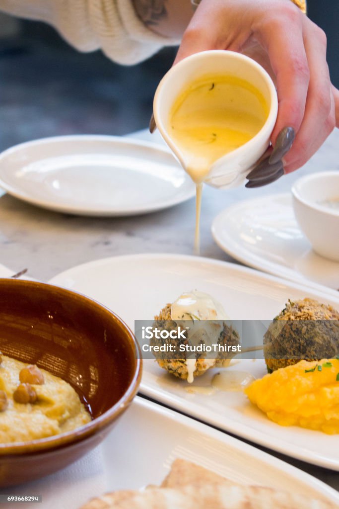 haggis candy haggis bonbon being pored with sauce Candy Stock Photo