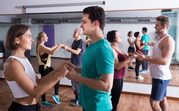 istock Happy  people dancing bachata together in dance class 693673410