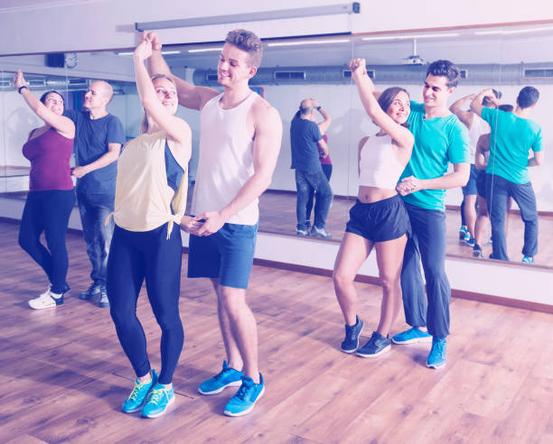 istock girls and men learning salsa 693673454
