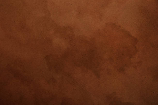 istock Old dark brown paper parchment background 693674148