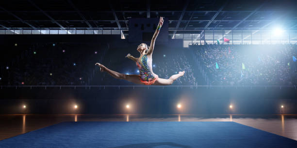 istock A gymnast girl makes a leap on a large professional stage 693674556