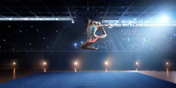 istock A gymnast girl makes a leap on a large professional stage 693674574