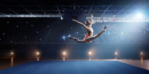 istock A gymnast girl makes a leap on a large professional stage 693674580