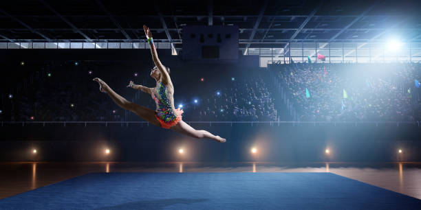 istock A gymnast girl makes a leap on a large professional stage 693674596