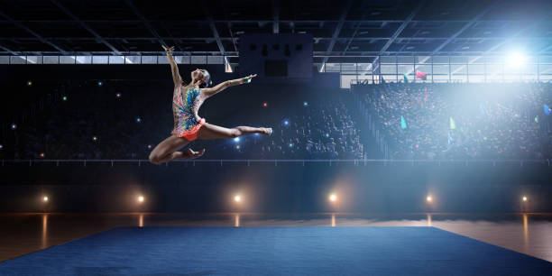 istock A gymnast girl makes a leap on a large professional stage 693674598