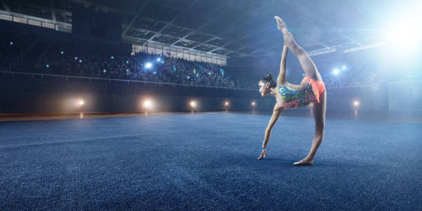 istock A gymnast girl makes performance on a large professional stage 693674642