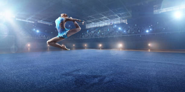istock A gymnast girl makes a leap on a large professional stage 693674688