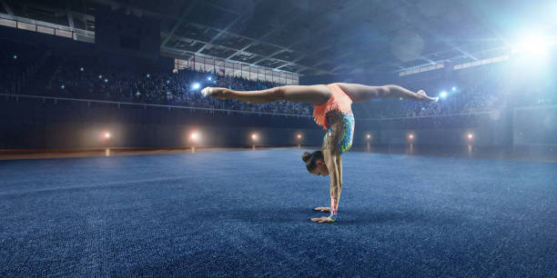 istock A gymnast girl makes performance on a large professional stage 693674696