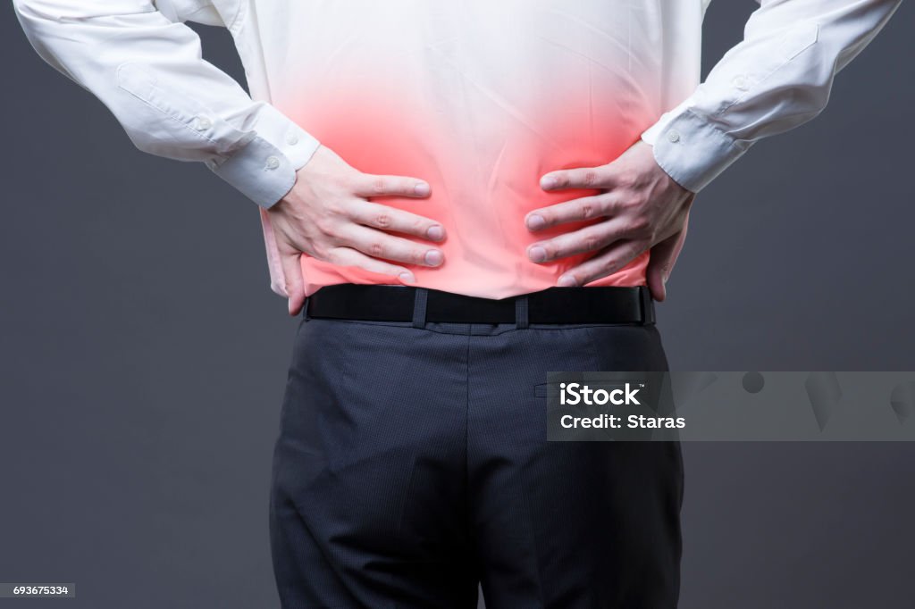 Back pain, kidney inflammation, ache in man's body Back pain, kidney inflammation, ache in man's body, studio shot with red spots Adult Stock Photo