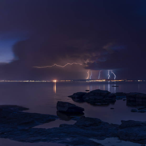 istock Dramatic nature background - thunders in dark sky over the sea 693677652