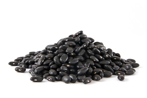 Heap of black beans on white background.
