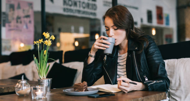istock Young woman drinking coffee 693682488