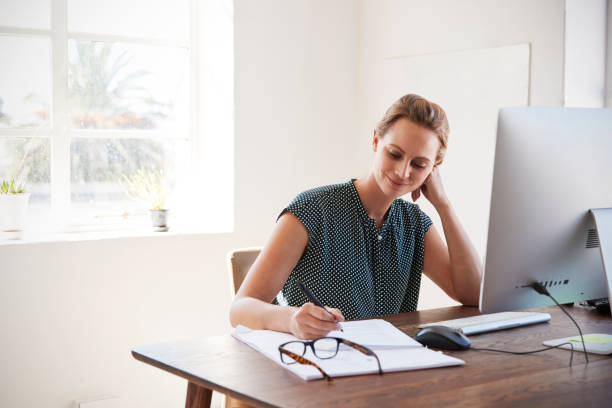istock Man and woman with documents in an office, smiling, close up 693682510