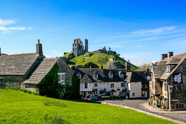 The castle ruins overlooking the village of Corfe in Dorset UK stock photo