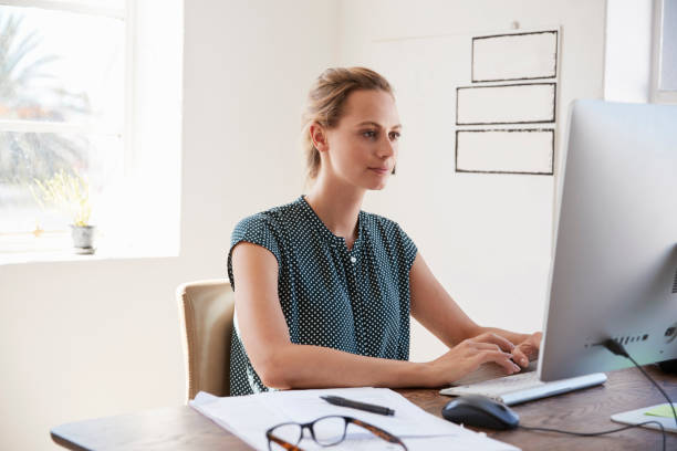 istock Man and woman with documents in an office, smiling, close up 693682796