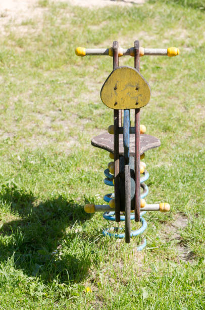 istock Empty wooden traditional swing on playground. 693682934